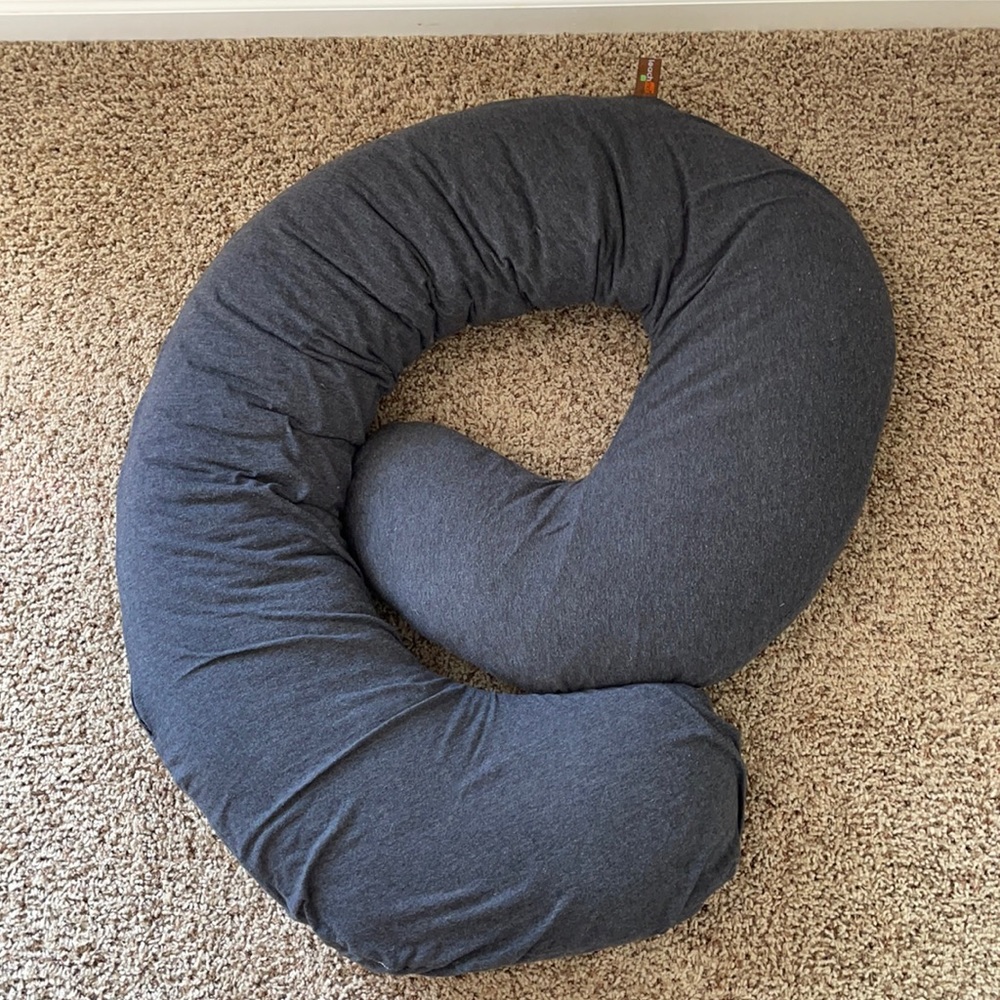 Snoogle pregnancy pillow with grey cover.